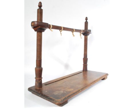 A 19th century Georgian elm wood book / bible stitching / sewing book binding tool frame being raised on a plinth base with u