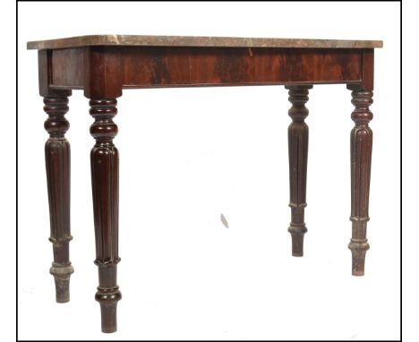 A 19th century Victorian mahogany and rouge marble top console table. The mahogany base raised on turned and tapering fluted 