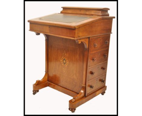 A 19th century VIctorian mahogany inlaid davenport desk. The hinged top with tooled leather writing skiver set over a bank of