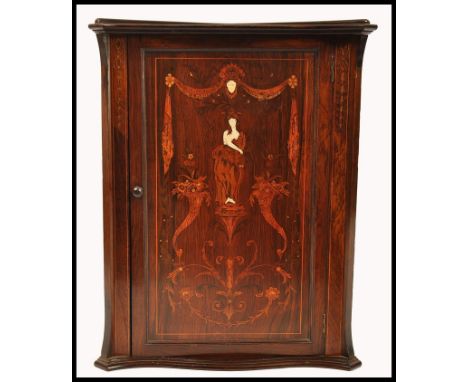 A 19th century rosewood marquetry and bone inlaid hanging corner cabinet. The door with stunning marquetry inlaid details of 