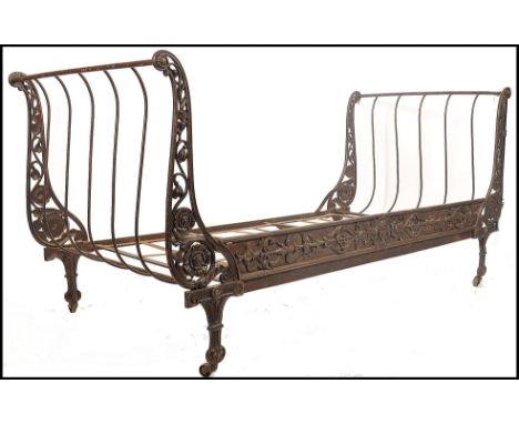 A 19th century French cast Iron day bed of folding form. The sleigh shaped ends with castors having slatted centre. The front