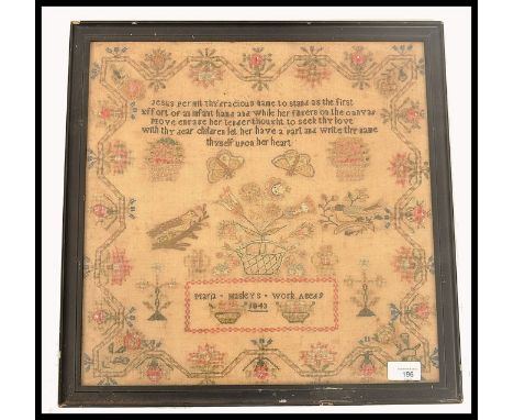 A 19th century needlepoint sampler dated 1843 by Maria Masleys age 9. The sampler panel with biblical verse over basket of fl