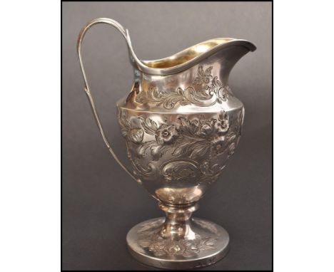 An 18th century George 3rd silver ewer / jug by maker Paul Storr, London, 1793. The ewer raised on circular base with relief 