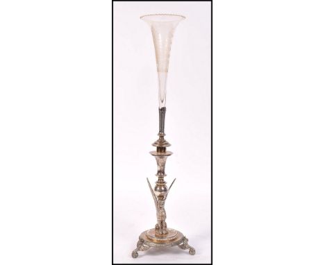An early 20th century Egyptian revival epergne raised on scrolled and winged tripod feet with stepped circular base with bead