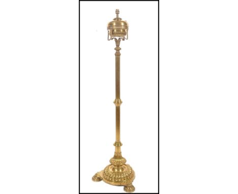 A 19th century brass tall oil lamp standard raised on a trefoil base with pad feet, turned reeded tall column with brass rese