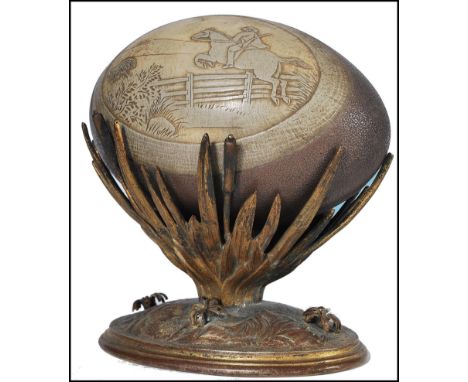 A late 19th century Australian gilt metal emu egg on stand. The stand with cast detailed lozenge base stylised with foliates 