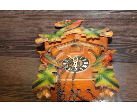 HUBERT HERR CARVED WOOD BLACK FOREST CUCKOO CLOCK
with a carved bird pediment over the cuckoo window, black chapter ring with