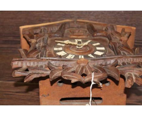 EARLY 20TH CENTURY BLACK FOREST STYLE CARVED WOOD CUCKOO CLOCK
wooden chapter ring with Roman numerals in white, ornate carve