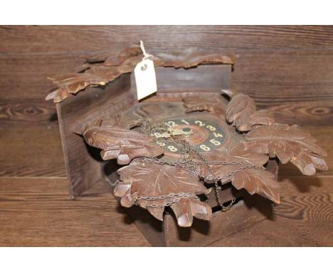 EARLY 20TH CENTURY BLACK FOREST STYLE CUCKOO CLOCK
with a carved bird pediment over the cuckoo window and black chapter ring 