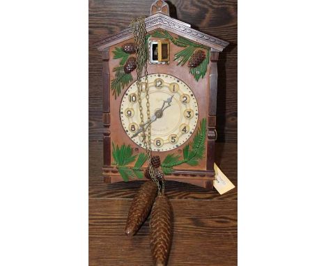 VINTAGE RUSSIAN CUCKOO CLOCK BY MAJAK
pine cone decorated plastic case, white dial with Arabic numerals, carved wooden pendul