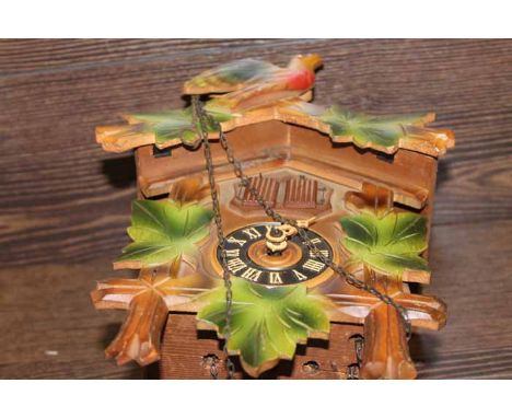 "REGULA" CARVED WOOD BLACK FOREST ONE DAY CUCKOO CLOCK
with a carved bird pediment over the double cuckoo window and, black c