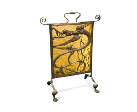 An Arts & Crafts fire screen,  the wrought iron frame with amber glass panel overlaid with copper dragon motif76 x 57 x 32cm