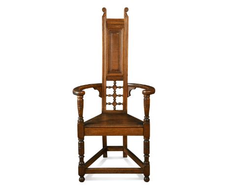 Attributed to William Bartlett for Liberty & Co., an oak Shakespeare Chair,  the upright panelled back with turned bobbin and