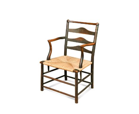 C. R. Ashbee for the Guild of Handicraft, a rush seated ash elbow chair, circa 1900,  of ladderback design with shaped armres