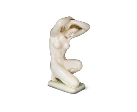 A large Goldscheider nude study, modelled in crouching pose on a rectangular base with black printed mark, impressed '8495/11