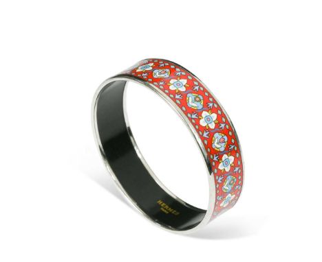 Hermès, Paris, a palladium plated and enamelled bangle,  of typical form, enamelled with a repeating frieze of stylised flowe