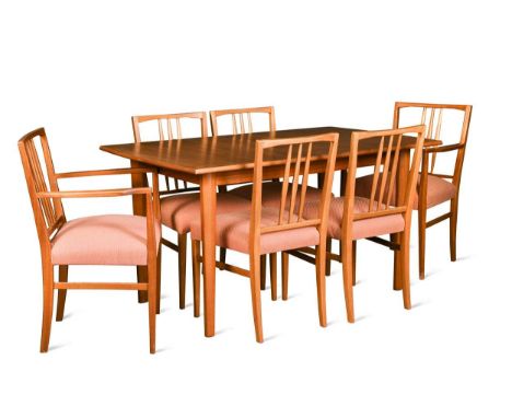 Gordon Russell, a walnut and teak extending dining table and eight chairs,  the stick back chairs to include two carvers, bra