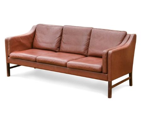 Skippers Mobler, a Danish brown leather three-seat sofa,  with loose cushions, raised on stained beech legs, labels to unders