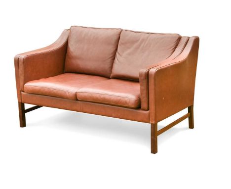 Skippers Mobler, a Danish brown leather two-seat sofa,  with loose cushions, raised on stained beech legs, labels to undersid