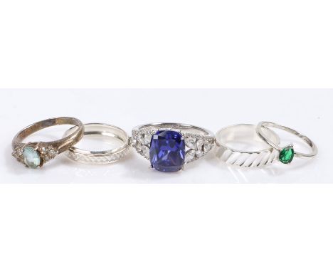 Five silver and coloured paste set rings, various sizes and styles, to include a substantial blue and clear paste set example