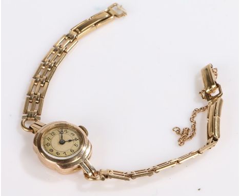 9 carat gold ladies wristwatch, the dial with Arabic numerals, manual wound, the case 15.5mm wide, on a 9 carat gold bracelet