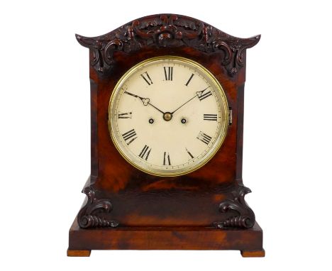 A William IV mahogany bracket clock - the case carved with flowers and foliage and chamfered corners, the cream painted dial 