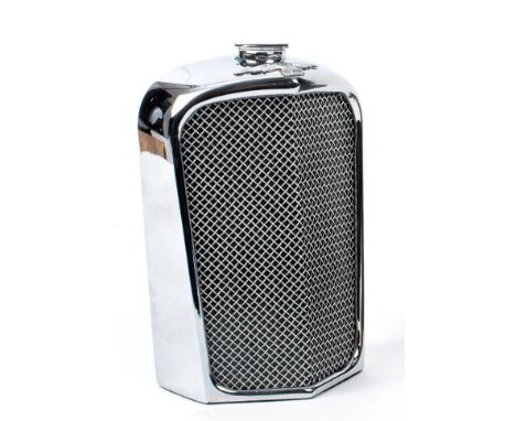 An 'SS Jaguar' radiator decanter by Ruddspeed, British, 1960s,chromed surround with wire grille, with enamel radiator badge a