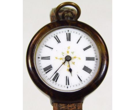 A tortoiseshell cased fob watch, adapted to a brown leather strap, the watch with white enamel dial and gold central floral m