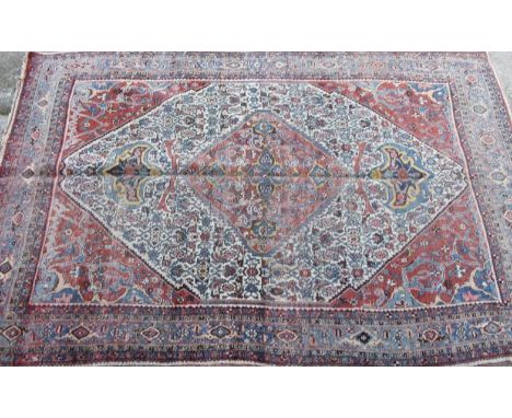 A 19thC Islamic carpet, in a floral geometric pattern on a white, blue and cream ground, 355cm x 228cm. Auctioneer Announce n
