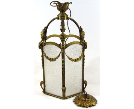 A Victorian style brass hanging lantern, of pierced domed outline, headed by an acanthus leaf top, with hanging garland surro