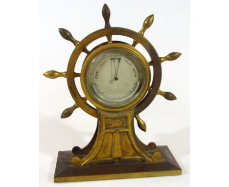 An early 20thC metal barometer, in ship's wheel casing, on a rectangular metal base entitled Tunbridge Fat Stock Show 1912, 3