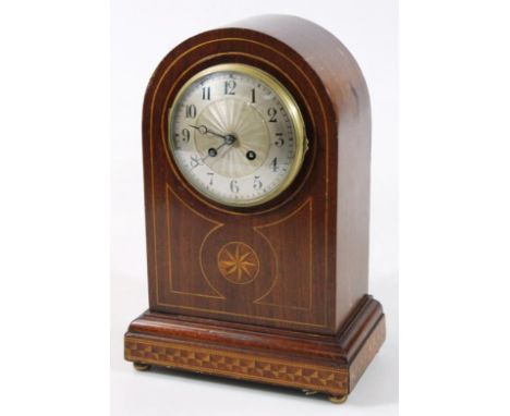 An early 20thC mahogany domed cased mantel clock, with raised 12cm dia. Arabic dial in part inlaid case, with keywind movemen