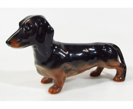 A Beswick large daschund figure, in two colours, printed marks beneath, 24cm wide.