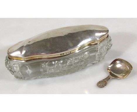 An Edwardian cut glass and silver dressing table jar, of shaped oval outline, Birmingham 1910, 15cm wide, and a silver caddy 