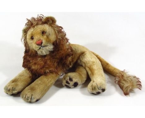 A mid-20thC Steiff Leo the lion, with metal button to the ear and growl action, 50cm wide.