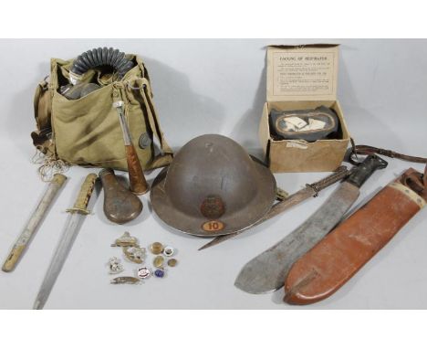 Various early 20thC and later bygones, collectables, etc., to include a tin war helmet of plain oval outline, 28cm wide, powd