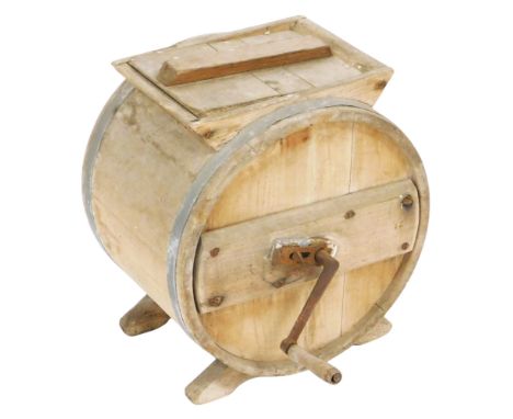 A vintage pine butter churn, of barrel form, with a cast iron handle, 37.5cm wide.