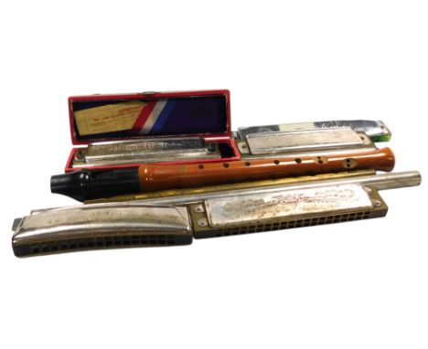 A Hohner Super Chromonica, boxed, further harmonicas, a Risetti recorder and two penny whistles.