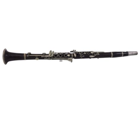 An early 20thC Couesnon &amp; Cie brown bakelite cased clarinet, 68cm long.