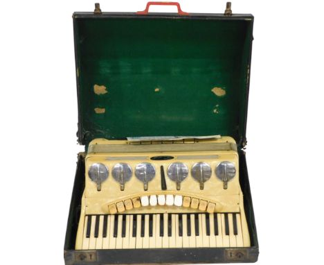 A Scandalli piano accordion, in a yellowed casing, 120 button, cased.