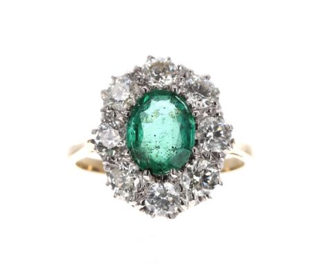 Impressive 18k emerald and diamond oval cluster ring, the emerald 1.32ct approx, in a surround of eight round brilliant-cuts,