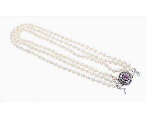 Good three strand pearl necklace with single ruby and diamond white metal cluster oval clasp, the single ruby in a surround o
