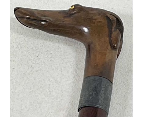 A silver collared walking stick with handle in form of a greyhound, length 84cm.Condition Report: No splits to the stick, but
