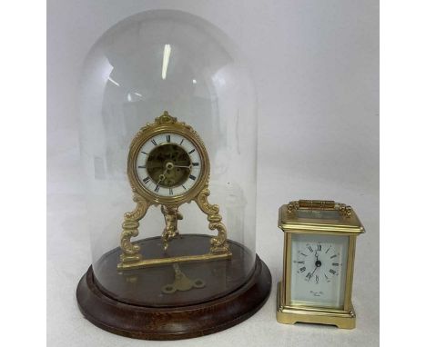 A late 19th century gilt metal cased timepiece of small proportions with Roman numerals to the white enamelled dial, cherubic