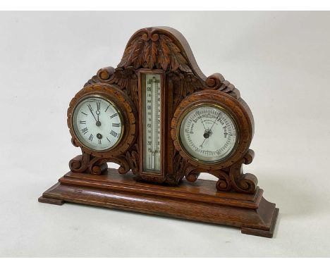 An early 20th century carved oak table clock barometer and thermometer, with white enamelled dials and stepped base, width 41