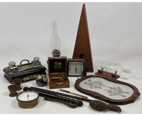 A group of collectors' items to include a brass aneroid barometer, an Art Deco wooden clock, a hard wood truncheon, a Black F