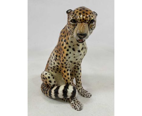 An Italian porcelain model of a cheetah, height 38cm, width 30cm.
