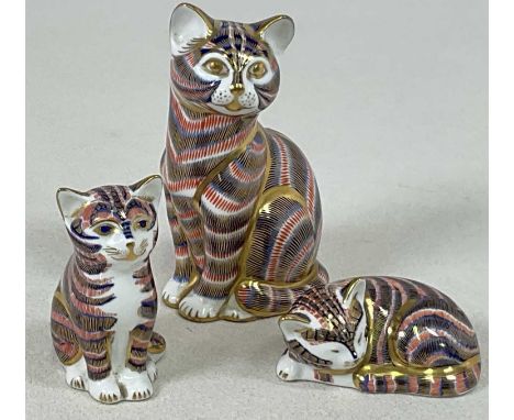 ROYAL CROWN DERBY; three cat paperweights, two sitting and one recumbent, two with silver stoppers, the other lacking its sto