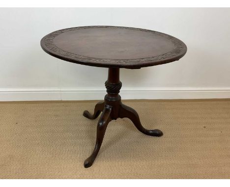 A 19th century mahogany tilt-top table with carved border turned support and tripod base, height 71cm, diameter 86cm.