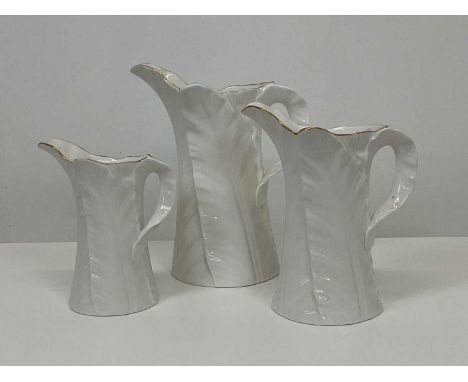 ROYAL WORCESTER; a set of three Fern Leaf graduated jugs, largest height 21cm.